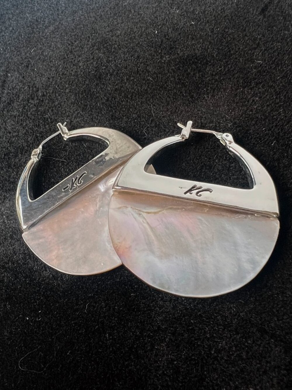Kenneth Cole mother-of-pearl hoop earrings.